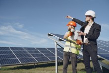 2 men standing by a solar panel array
