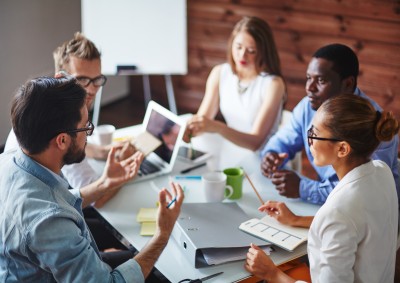 Group of 5 people having a meeting while seated