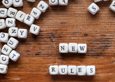 Tiles spelling out "new rules"