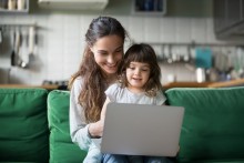 Mum and daughter looking at laptop