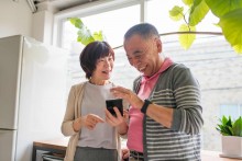 Residents using iPad standing by window