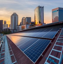 Rooftop solar panels with city skyline background