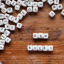 Tiles spelling out "new rules"