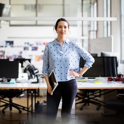 Woman in business attire standing with hand on hip