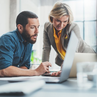 Two people looking at a laptop